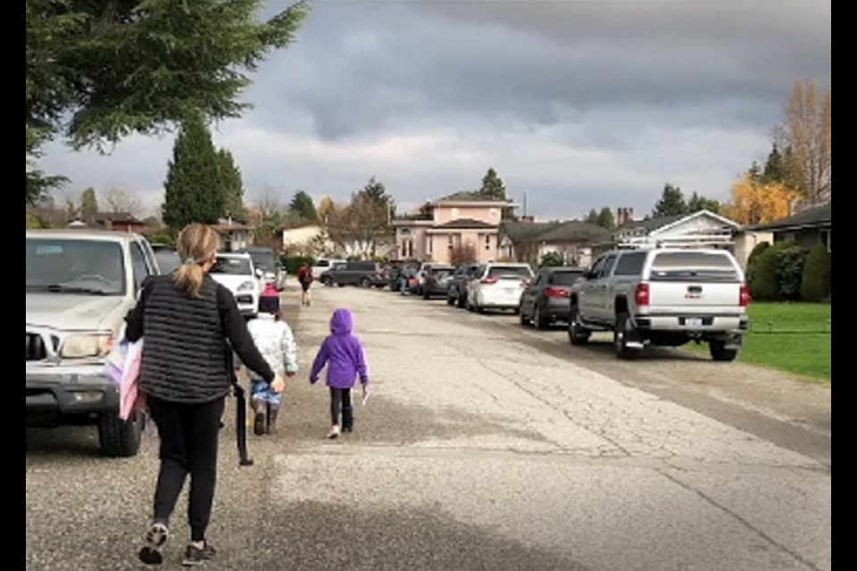 A photo presented to the Burnaby's traffic safety committee shows parents at children walking on the road near Sperling Elementary because there are no sidewalks.