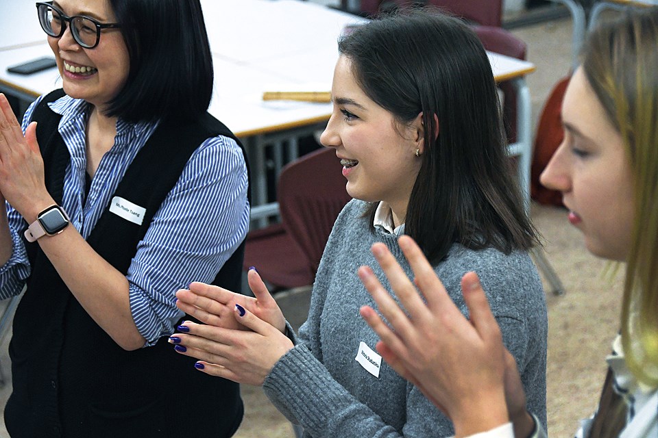 BCIT student Victoria Shabatina, centre, volunteers at a pilot program for Ukrainian teens at Burnaby North Secondary School in January.