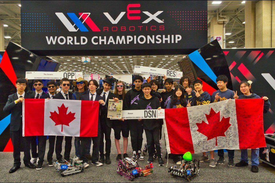 Members of the Swarm pose for a photo with their robots at the VEX Robotics world championships in Dallas, Texas last week.