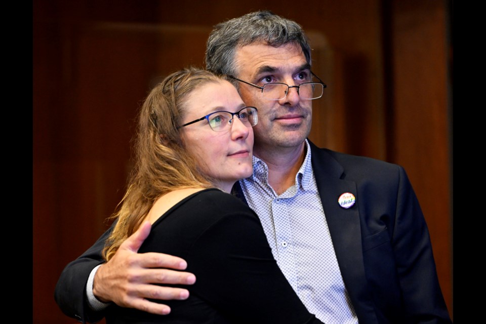 Patrick Johnstone watches the results of the municipal election with partner Antigone Dixon-Warren.