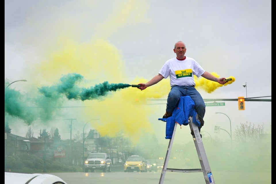 Anti-logging protester Ben Holt holds up traffic on a ladder in the middle of Grandview Highway in Burnaby on April 18.