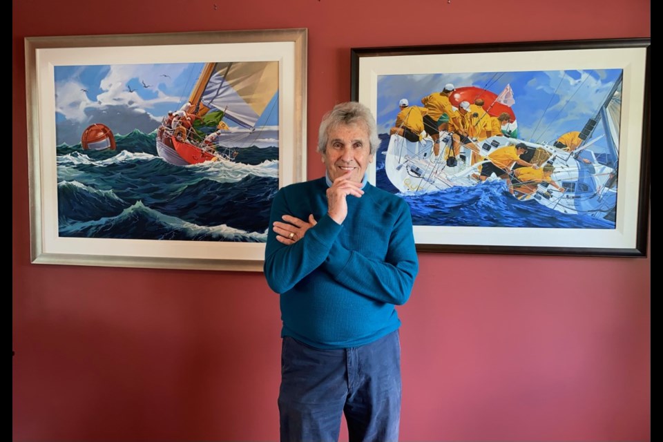 Barry Walker stands with two of his paintings in his daughter's Burnaby home. The pair will host an art show of Walker's painting on June 5.