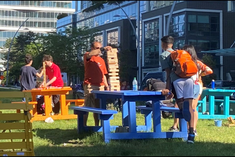 Families and residents soak up the sun as they hang out at Burnaby's BC Parkway planning festivities.