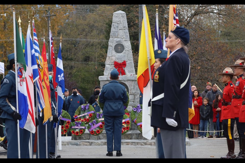 The colour guard stands before the cenotaph as community members and legion members lay wreaths at Confederation Park in Burnaby, B.C.