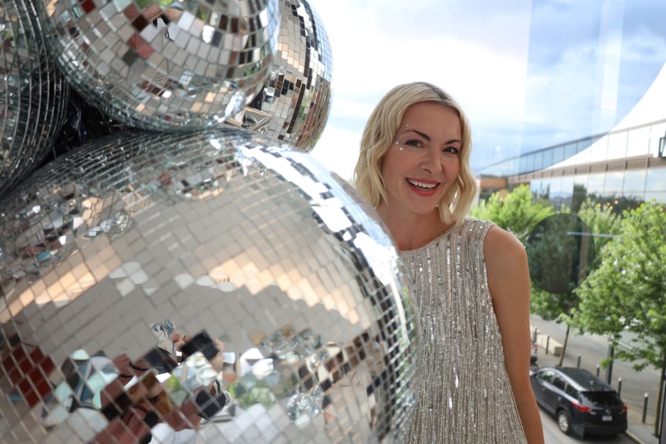 Mirrorball is a public art installation around the Amazing Brentwood mall and will run throughout the summer. Shannon Heth, president of Milk Creative Communications which put on the event, poses on the "Bridge of Reflection." 