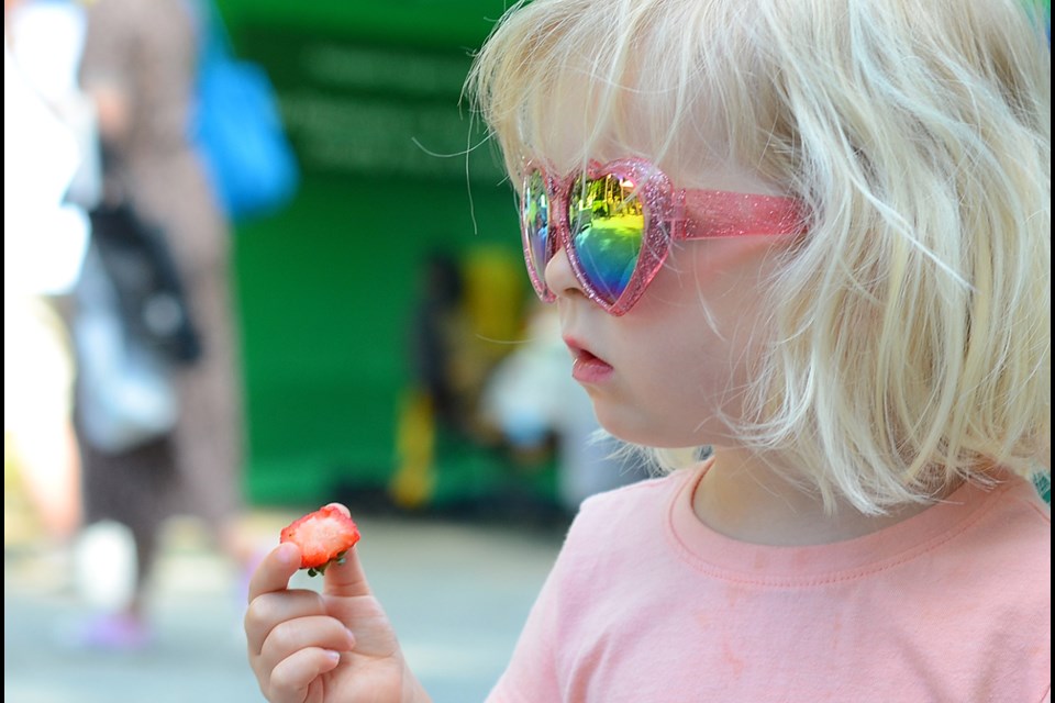 Eva Owen, 3, samples some of the wares at the June 3 New West Farmers Market.