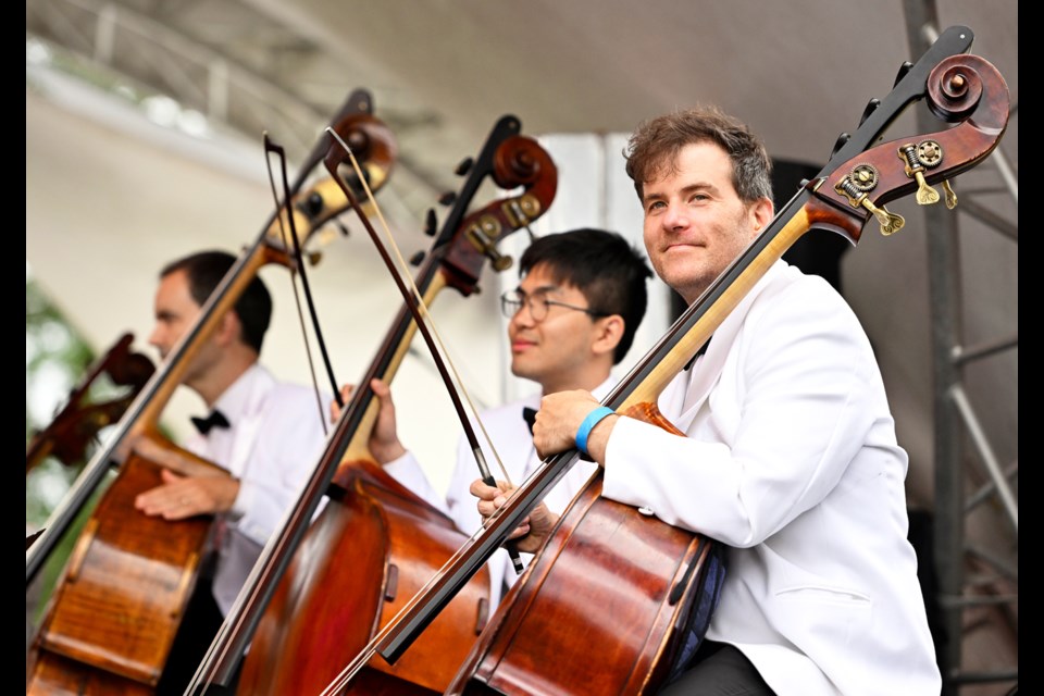 Vancouver Symphony Orchestra strings section plays at the Symphony in the Park event in Burnaby, B.C. 