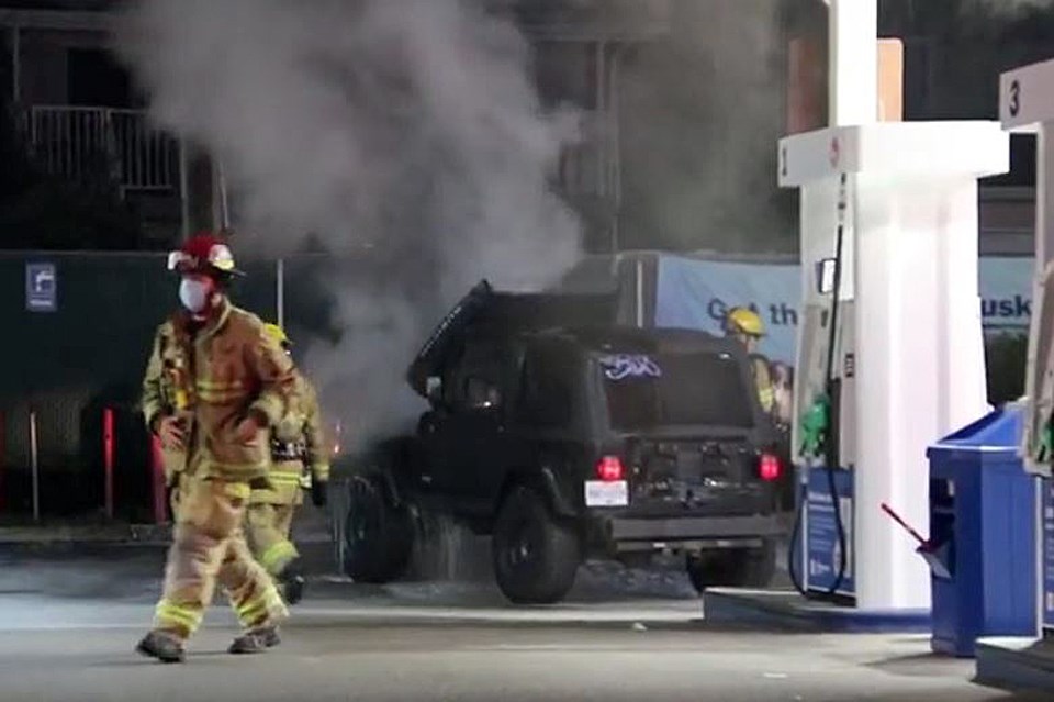Firefighters douse a smoking vehicle at the 975 Willingdon Ave. Mohawk gas station early Monday morning.