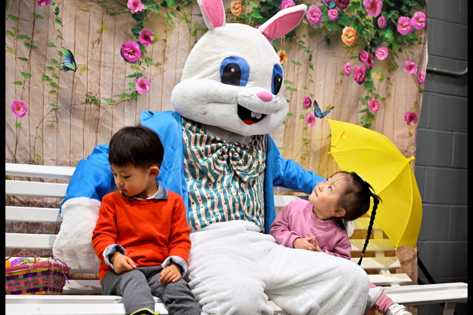 Camilla Wu eyes the Easter Bunny, with Ethan Liu, at the Easter Carnival held at Moody Park Arena on Saturday, April 8.