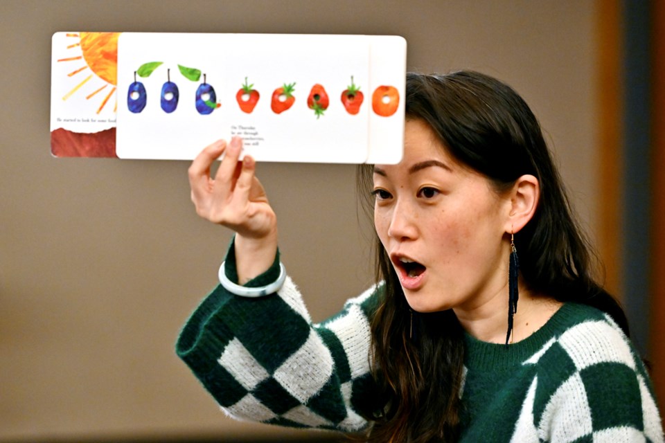 Elaine Su, a teacher-librarian and the 2022 Citizen of the Year, reads to families during a Mandarin storytime she hosted on Saturday, Jan. 7 at the library for Lunar New Year.