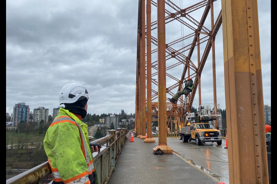 The Pattullo Bridge has reopened to traffic as of Sunday afternoon. Here, TransLink was doing some inspections that required overhead rope access on Saturday. 