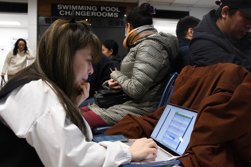 Joy Hsu prepares to register her kids for swimming lessons in-person at Bonsor Recreation Complex in Burnaby.