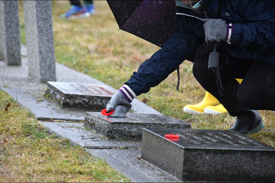 Students from Skwo:wech, Herbert Spencer and F.W. Howay elementary schools and a contingent from Urban Academy turned out on a rainy Friday morning Nov. 4 for the No Stone Left Alone remembrance ceremony at Fraser Cemetery.