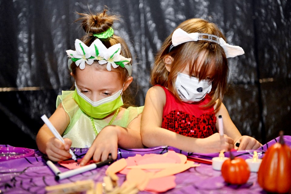 Five-year olds Vera, left, dressed as Tiana, and Caroline, dressed as Hello Kitty, check out the Halloweekend activities at Fraser River Discovery Centre.