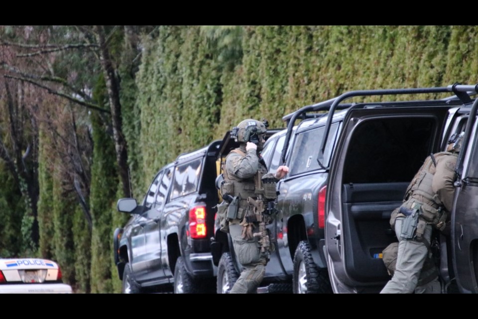 Emergency Response Team officers gear up for a standoff at a Burnaby hotel Tuesday.