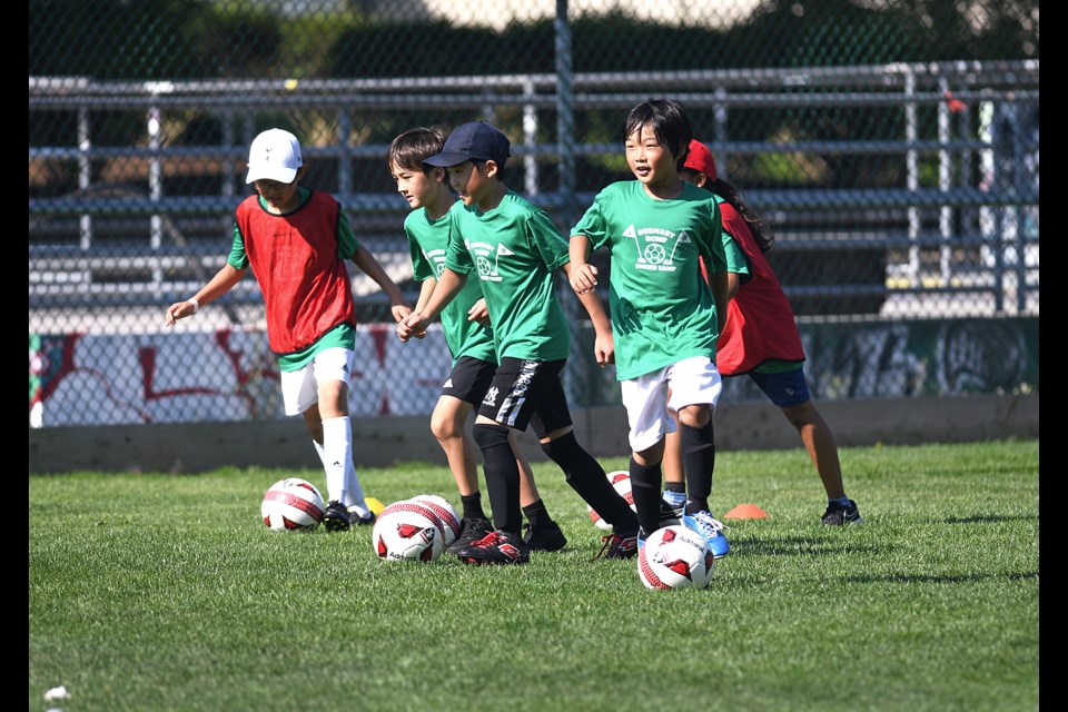 A group of players execute a drill during the RCMP youth soccer camp at Bonsor Park last week. 