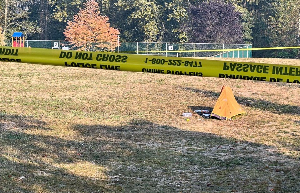 A tent remains behind police tape at Burnaby's Broadview Park, where an on-duty officer was killed during all altercation with a man in a tent Tuesday. 