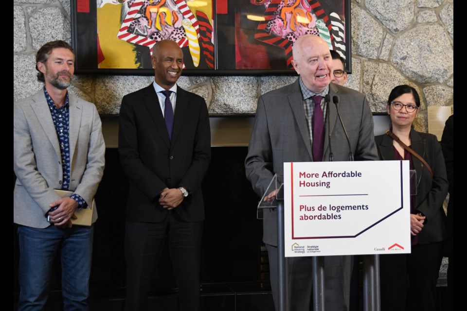 Burnaby Mayor Mike Hurley (at podium), federal Minister of Housing and Diversity and Inclusion Ahmed Hussen (second from left), and president of Catalyst Community Developments Society Luke Harrison (left) announce $154.5 million in funding to affordable rental developments in Burnaby.