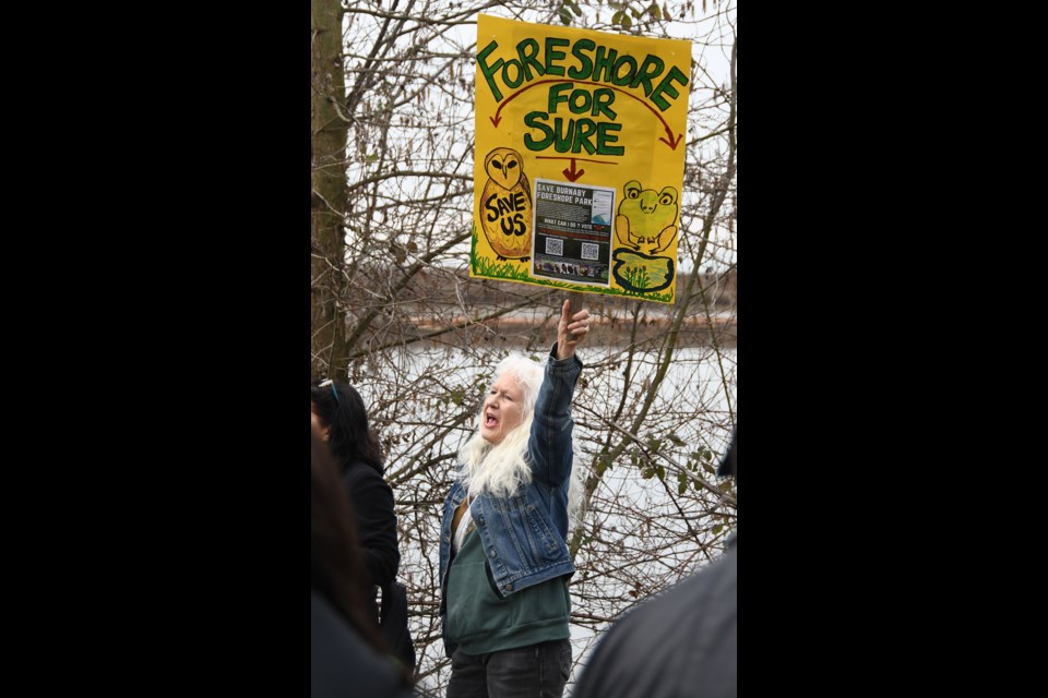 Burnaby resident Cathy Boyes protests removing 21 acres of parkland at Fraser Foreshore Park on Sunday, March 19.