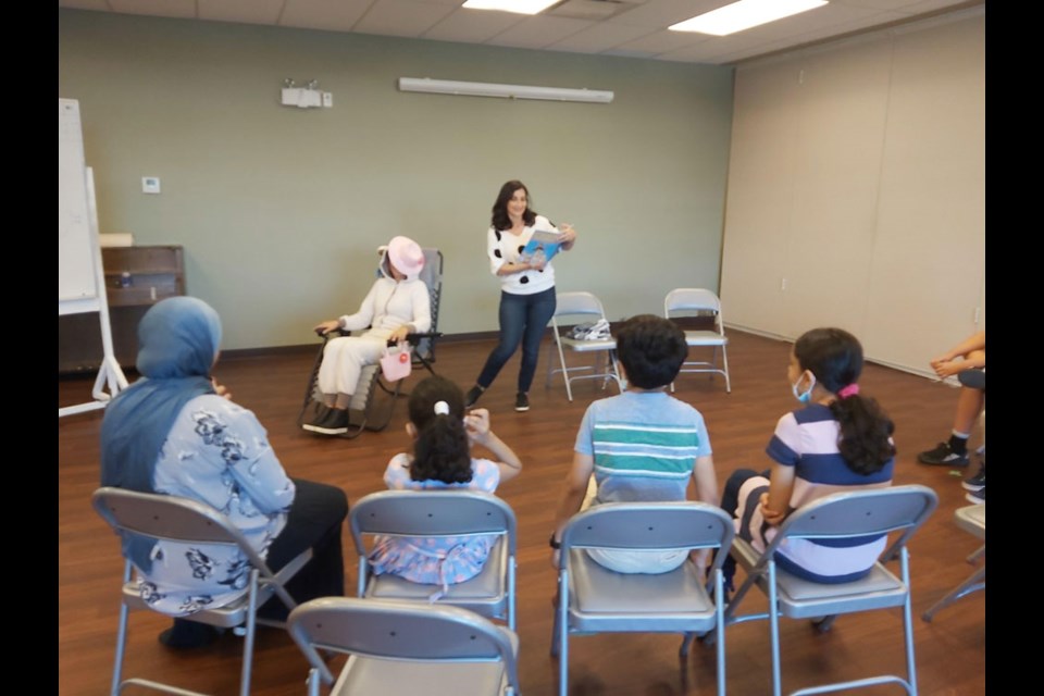 Rania Issa, Facilitator at Burnaby Neighbourhood House, running a book reading session for families at the South House.