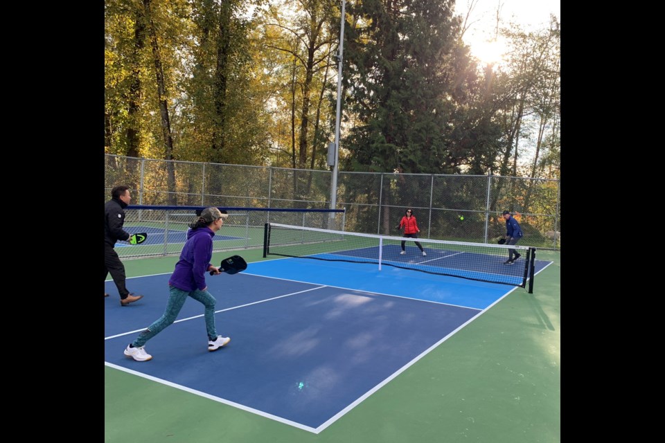 Mayor Mike Hurley celebrated the opening of the new dedicated pickleball courts at Squint Lake with members of the Burnaby pickleball community.