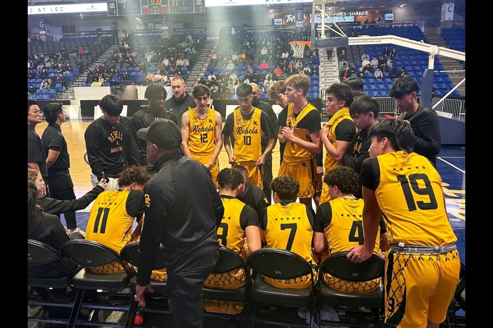 The Burnaby South Rebels huddle up during a timeout during its opening game of the 2024 B.C. AAAA boys basketball provincials.