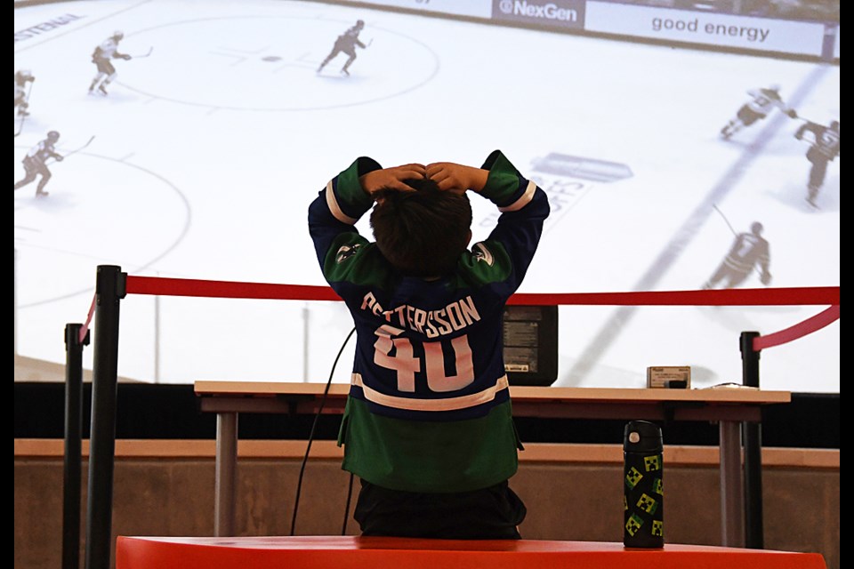 A missed scoring chance gets a young Canucks fan out of his seat at a Stanley Cup playoff viewing party at Burnaby's Rosemary Brown Arena Tuesday.