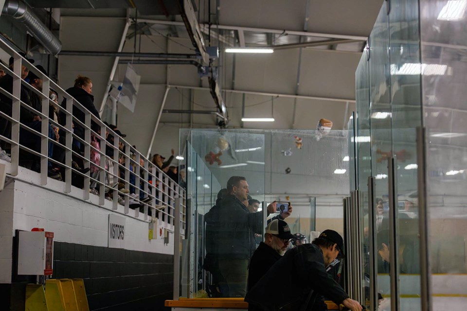 Fans throw stuffed animals over the benches and onto the Burnaby Winter Club ice after the Grandview Steelers scored in the first period on Sunday, Dec. 10, 2023.