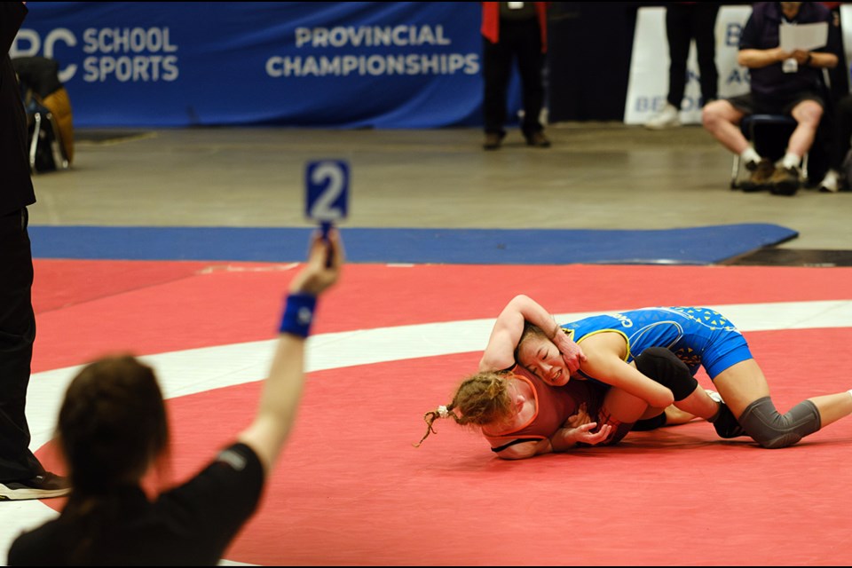 Cariboo Hill Grade 9 student Rylie Chew (in blue) competes at the B.C. high school wrestling championships last month. 