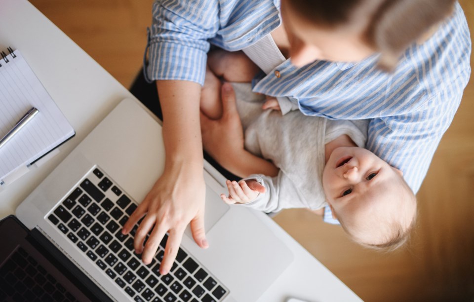 Mom with baby working on computer