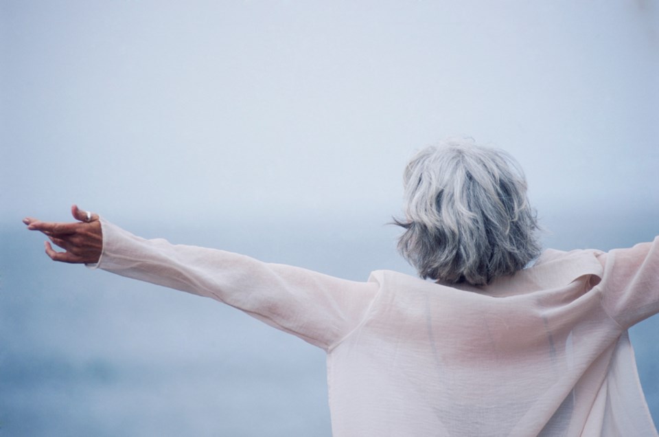 grey haired woman embracing life