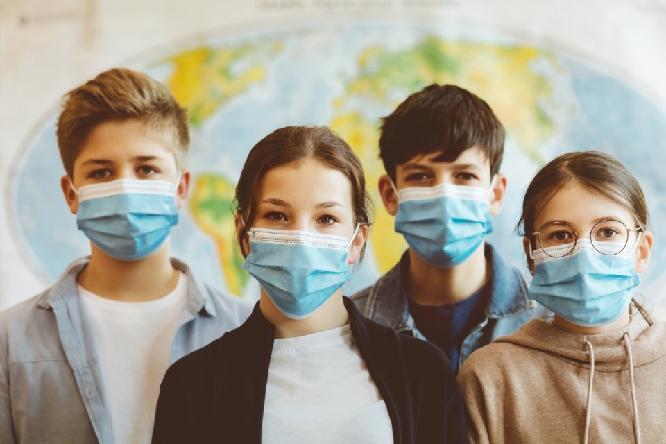 Teenagers in COVID masks