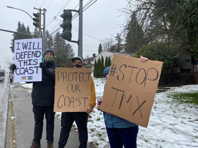 Kevin Schwantje, Justin Miranda, Lily Nichol, from left, waved signs on East Columbia Street near the Brunette Fraser Regional Greenway – an area where hundreds of trees will be cut down and endangered species could be put at risk by the TMX pipeline expansion project.  Contributed