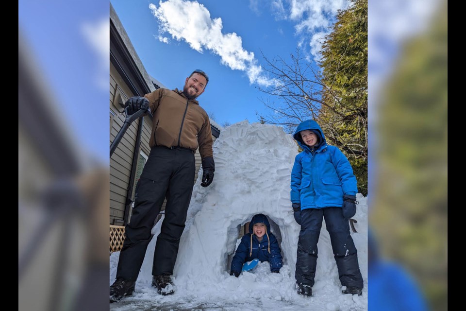 Adam Wasik, at left, was the construction site supervisor for the Wasik family fort after Saturday night saw more than 20 cm of snow dumped on New West. Sons Atlas, 9, (in fort) and Bishop, 7, enjoyed the fruits of their labours on a sunny Sunday afternoon.