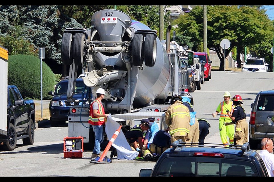 Emergency crews perform CPR on a flagger fatally injured by a cement truck on Aug. 11, 2021 at the Alto on Capitol Hill worksite at Hastings Street and Ellesmere Avenue. Photo Ryan Stelting 