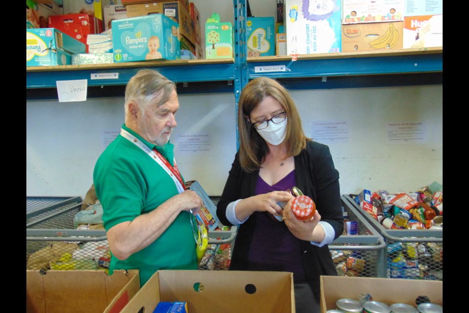 Joanne Weston NDP candidate for Kitchener South-Hespeler helping sort food items with volunteers for the Spring into Action Food and Fund Drive.                              