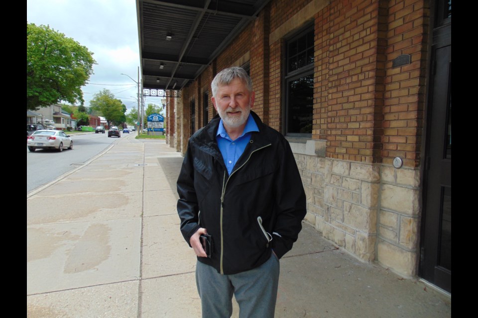 David Menary stands outside Galt Arena Gardens. The former sports journalist and current author has penned a book chronicling the Cambridge landmark's 100th anniversary.                              