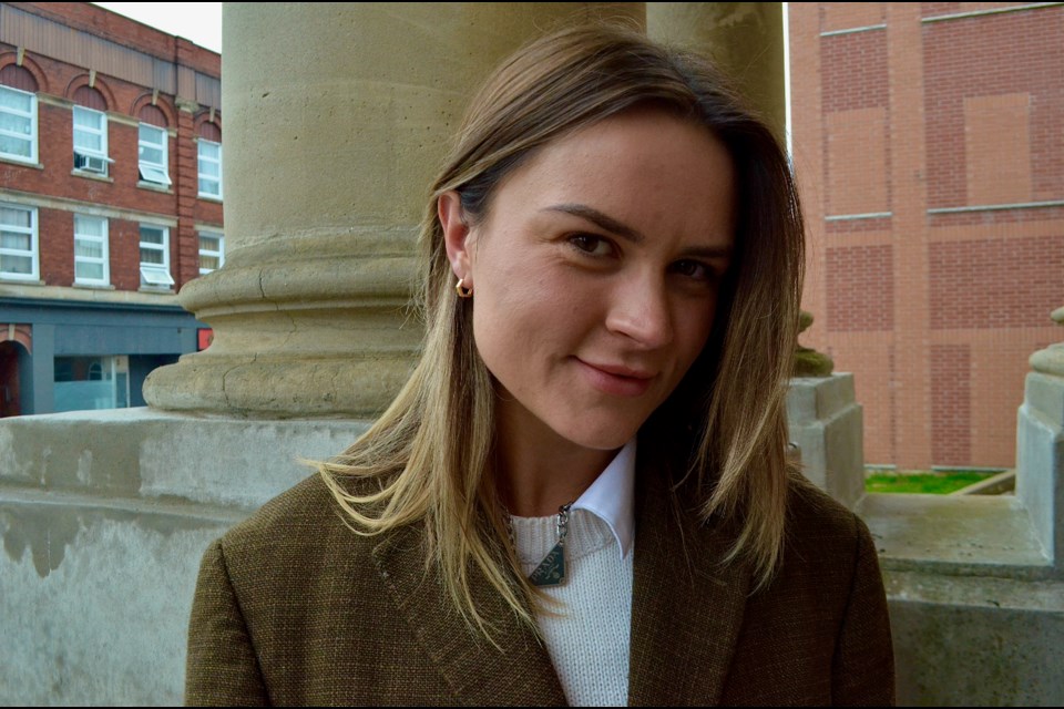 Mixed-media artist Wilks Chaplin on the steps of one of her favourite buildings in Cambridge, the historic Galt Carnegie Library.