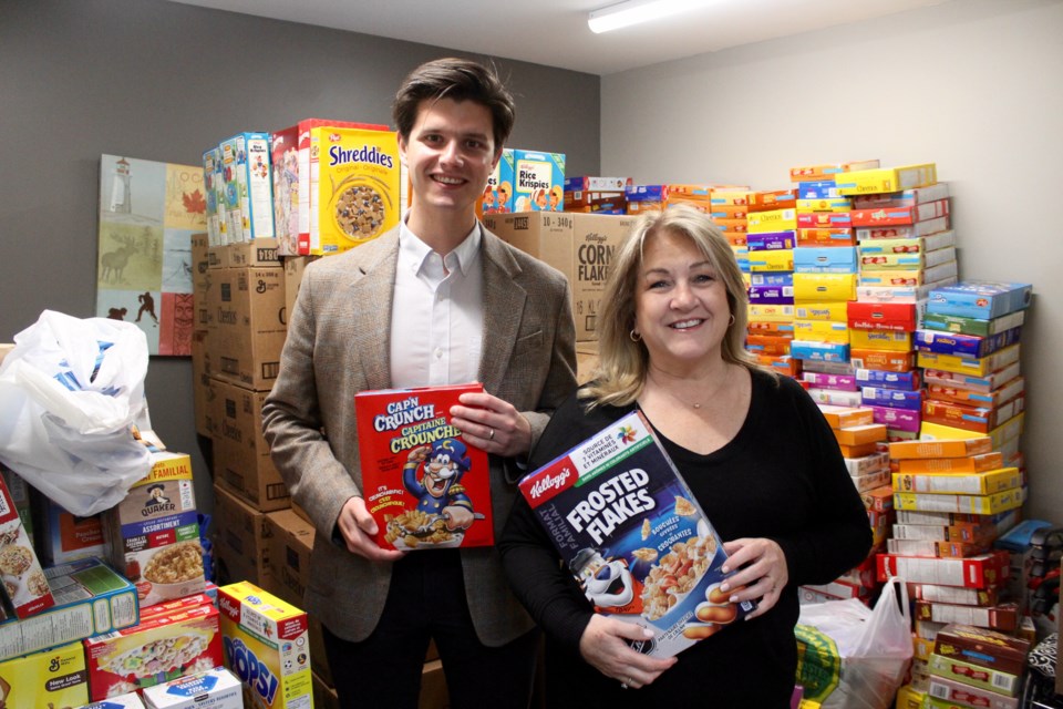 Jack O'Donnell (left) and Lisa Harlock stand inside an office full of cereal at Royal LePage Crown Realty on Hespeler Road.