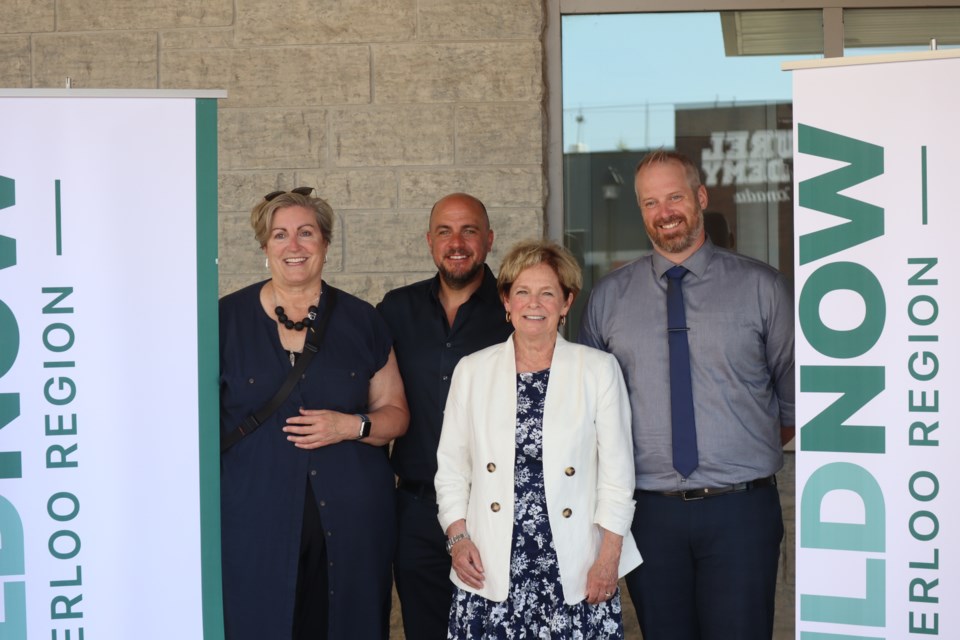 Regional Chair Karen Redman (middle) stands with Philip Mills, CEO of Habitat for Humanity Waterloo Region (right) at an event at Cambridge City Hall on Thursday.