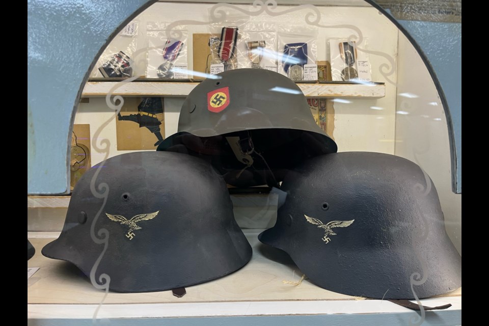 Nazi war helmets are set up in a display case inside Southworks Antiques.