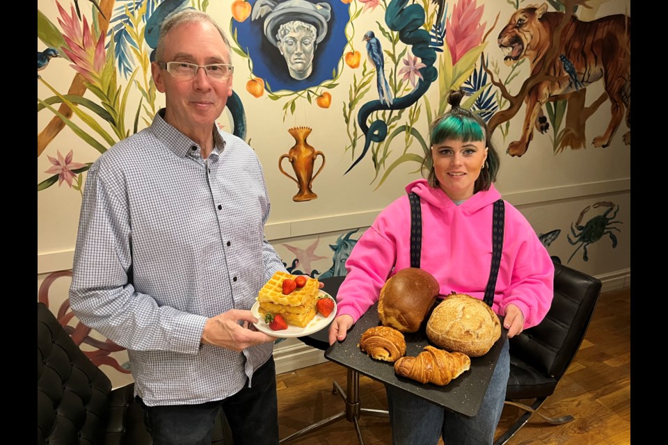 Chris Sharpe and his daughter Andrea show off Belgium waffles and bakery items made by Daniel Angus that will anchor the menu at Flight Cafe and Lounge on Main Street.