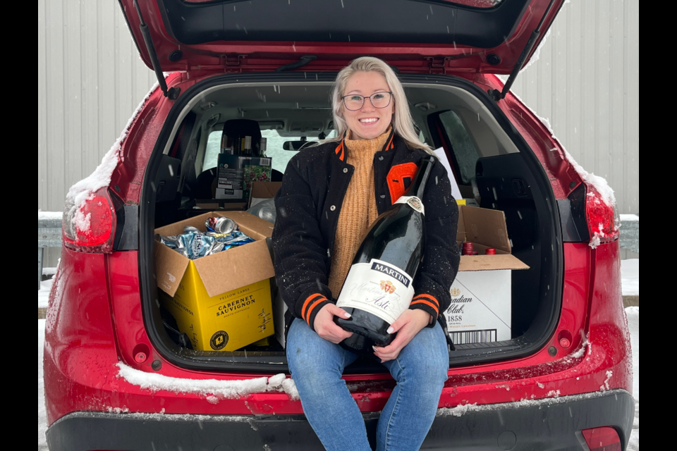 Maddie Gardiner sits in the back of her car that's full of bottles and cans she collected. Proceeds from the empty returns are being split between Tyson N Friends pet rescue and the Cambridge and District Humane Society.
