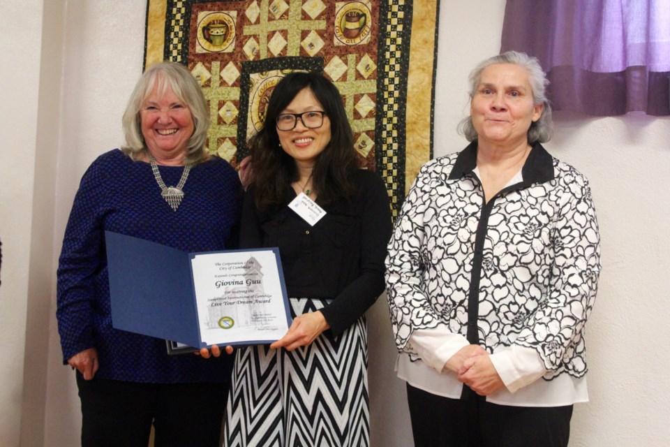 Mayor Jan Liggett (left) presents Giovina Guu with a certificate, alongside Dianne Long of Soroptimist International of Cambridge, on behalf of the city for being recognized as a Living Your Dream Award recipient.