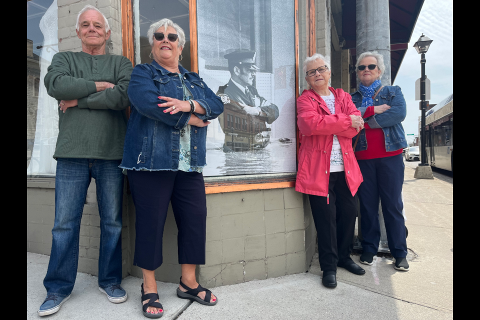Jack Shuttleworth's son Ron (left), daughter Linda Cation, wife Lorraine and daughter Brenda Hubert stand arms crossed in the same spot the original photo of their father was taken during the 1974 Cambridge flood.