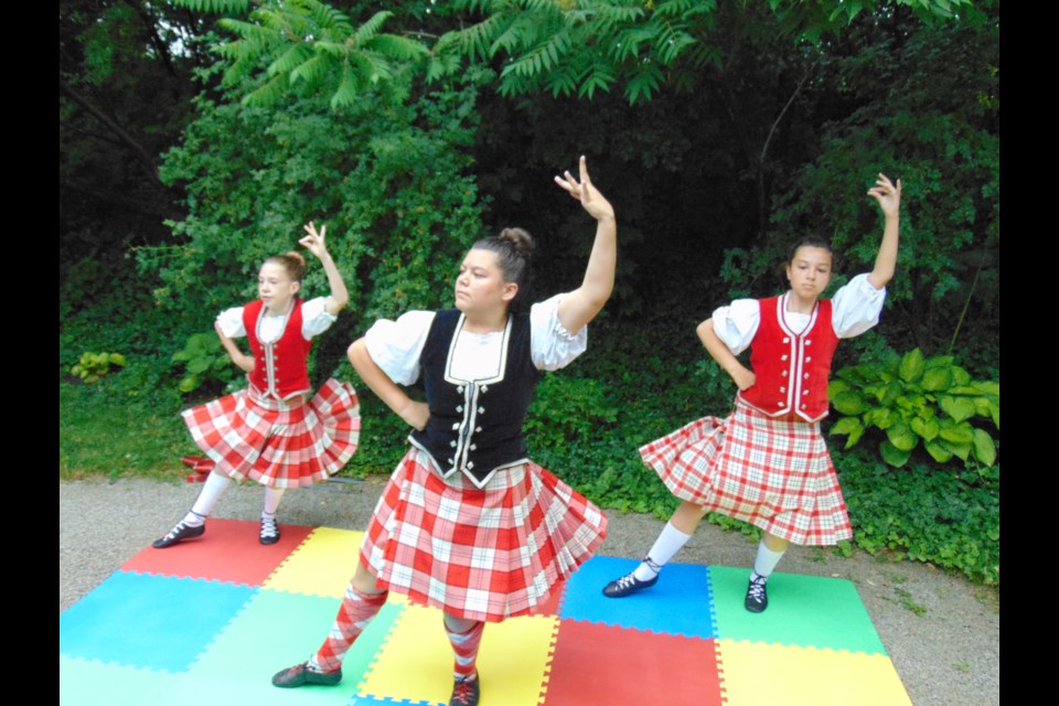 (left to right) Scottish Highland dancers, Kennedy O'Malley, Emmaline Henry, and Nadia Brum get ready for the Cambridge Scottish Festival on July 15-16.                               
