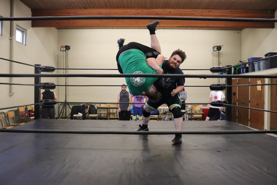 Students at Cross Body Studios hip toss each other in a practice match in Cambridge