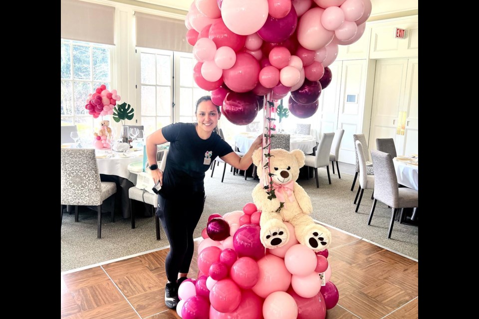 Ana Maria Arias stands with her balloon arrangement she made for Langdon Hall in Cambridge. 