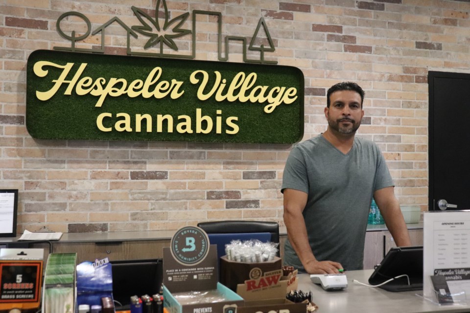 Ramandeep Gill stands behind the counter at Hespeler Village Cannabis