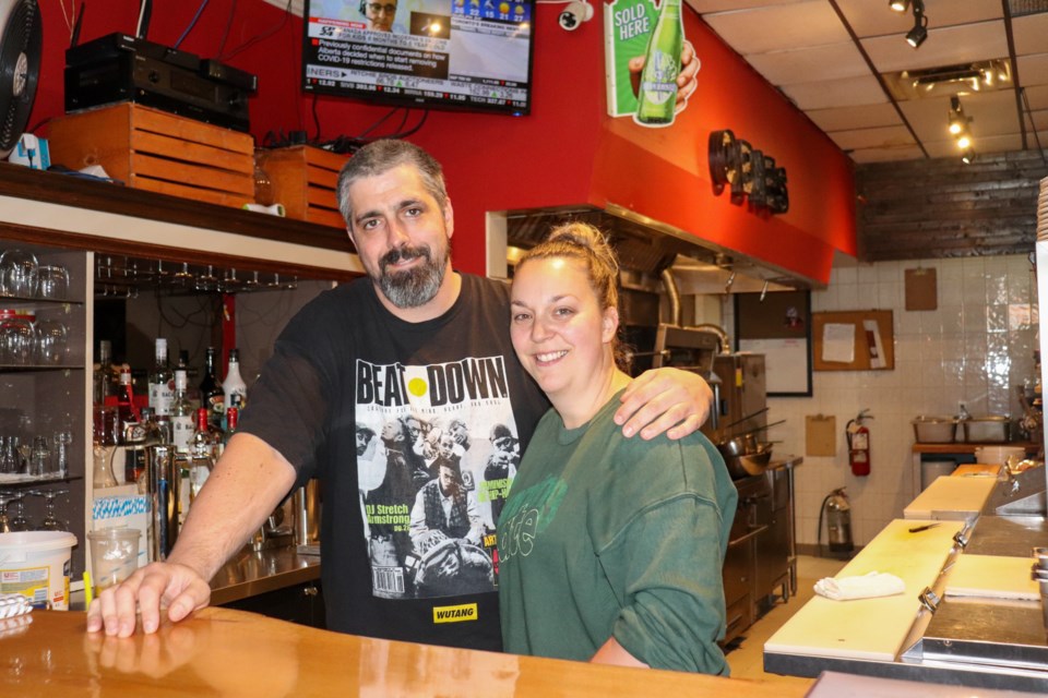 Justin and Lyndsey O'Brien stand behind the counter at Obie's Bar and Grill.